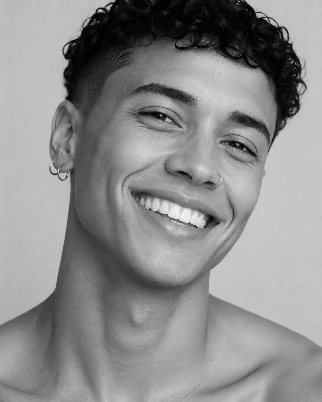 Black and white close portrait of a smiling man