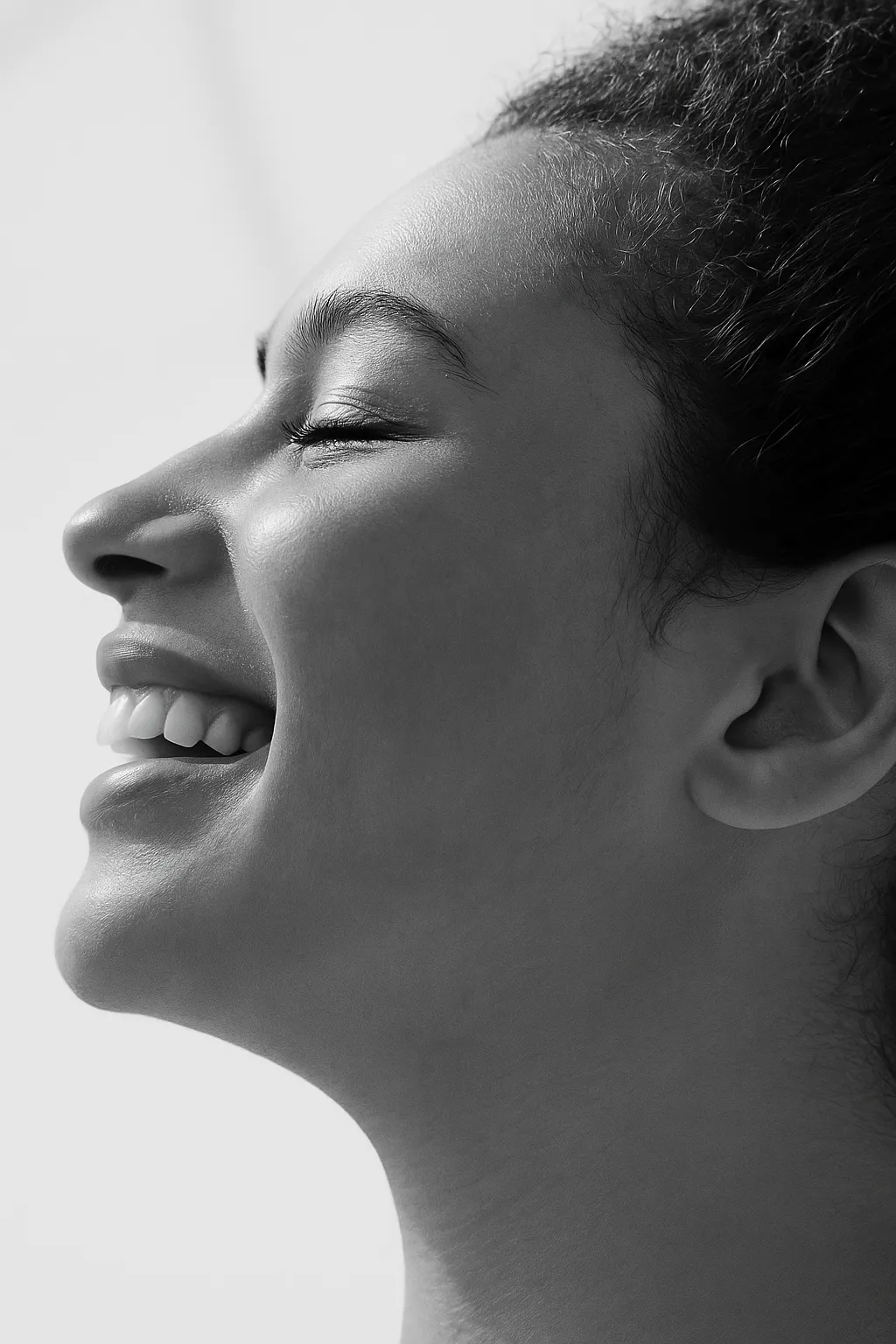 Soft black and white study of a face in profile with eyes closed